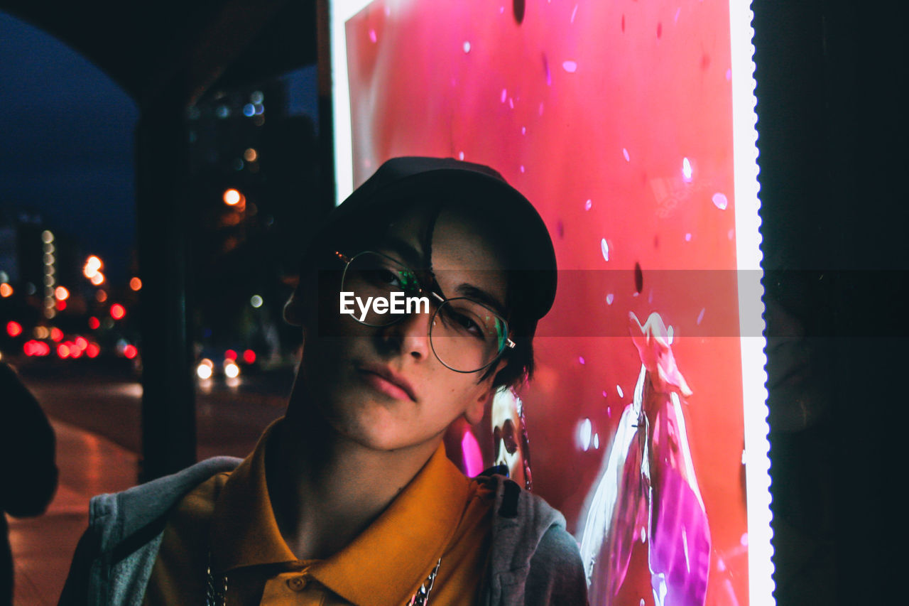 CLOSE-UP PORTRAIT OF A YOUNG WOMAN WITH EYEGLASSES