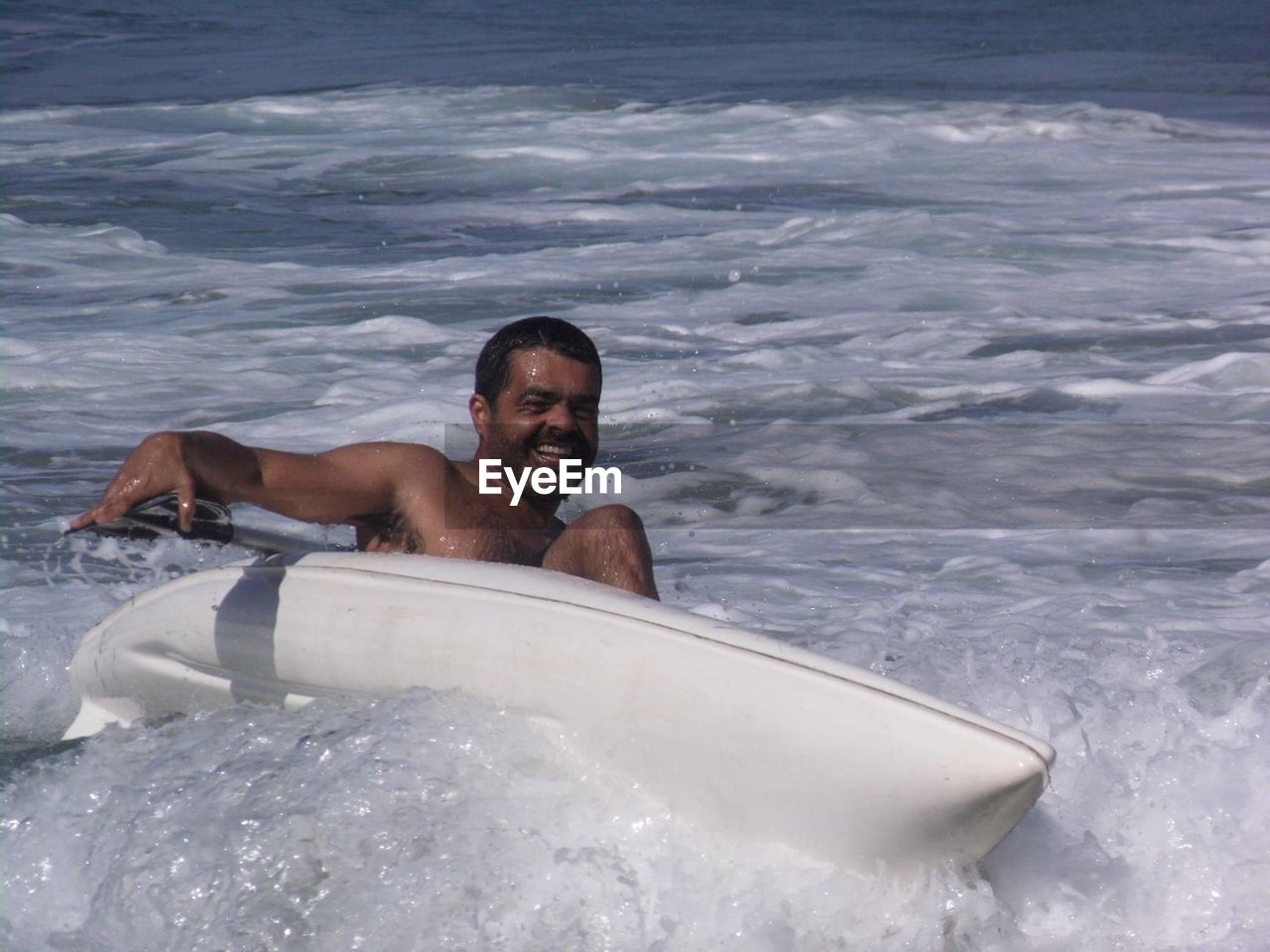 Man kayaking in sea