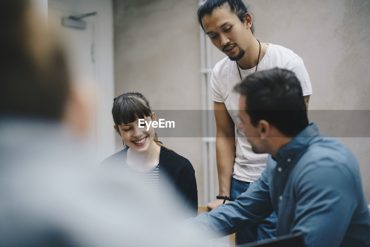 Multi-ethnic computer programmers discussing in office