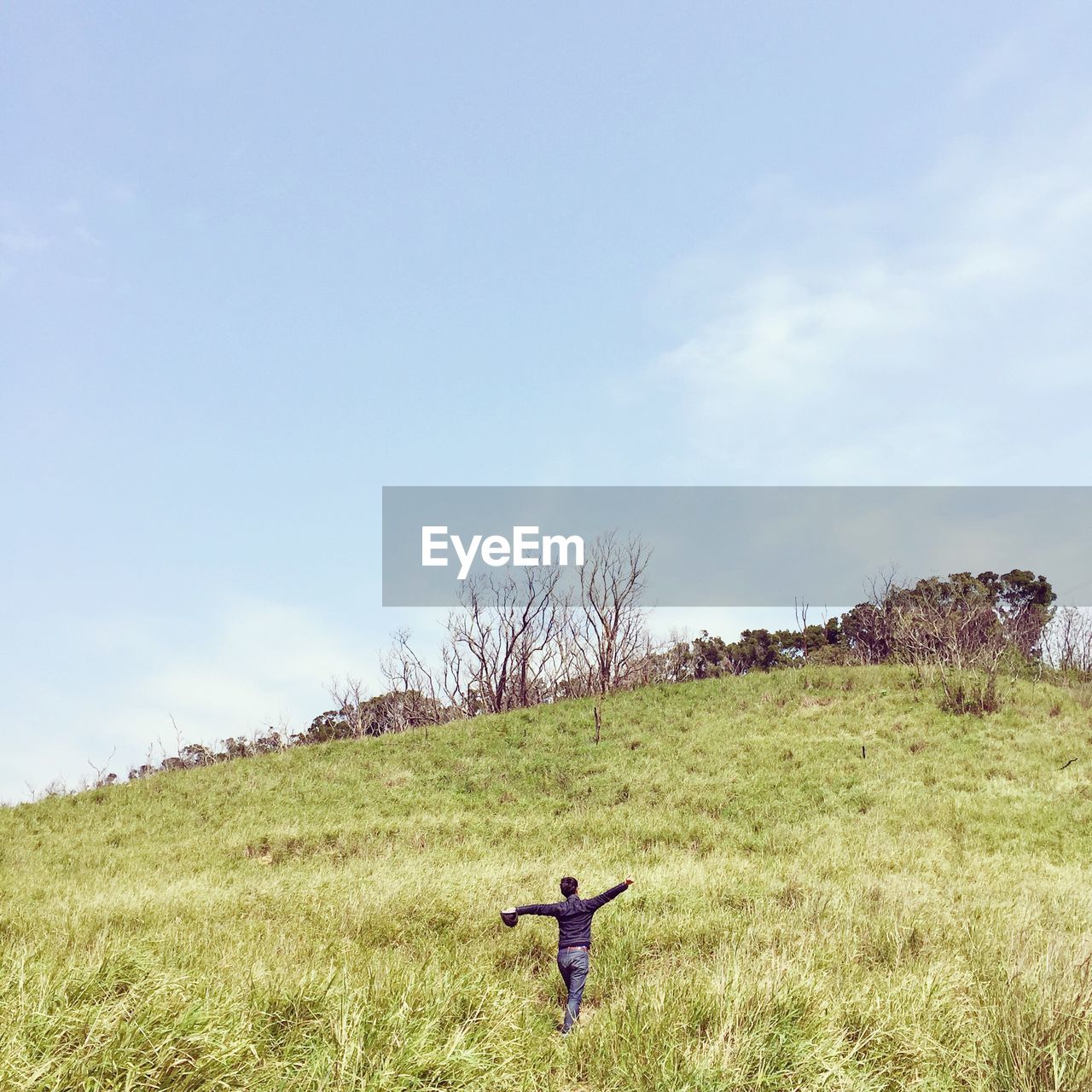 Man walking on grassy field