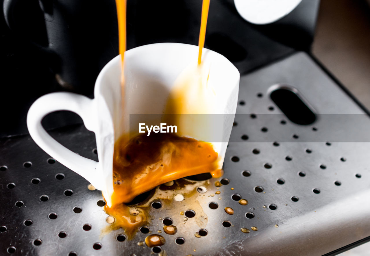 Broken coffee cup on espresso machine