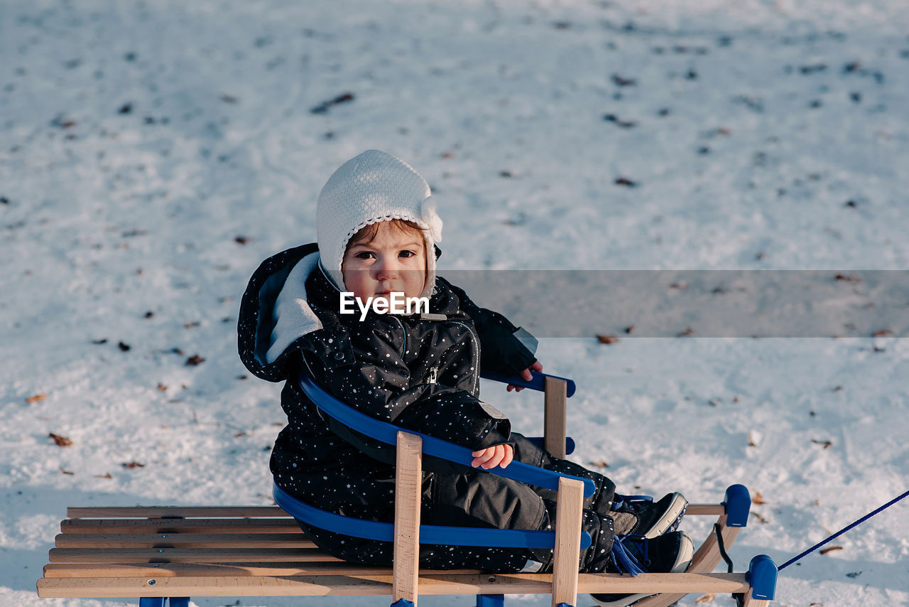 Girl sitting in snow