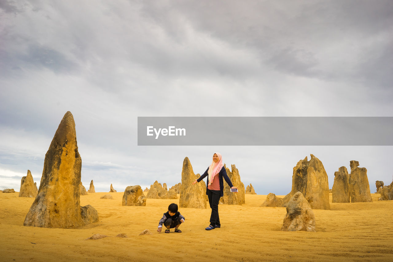 Mother and son against rocks at desert