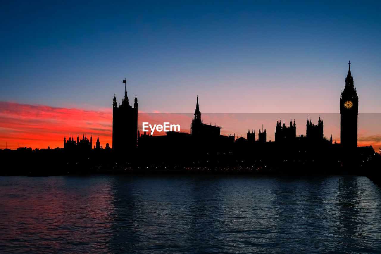 Orange sunset with silhouette of elizabeth tower, big ben, and the houses of parliament