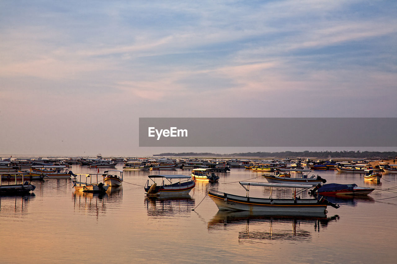 BOATS MOORED IN HARBOR