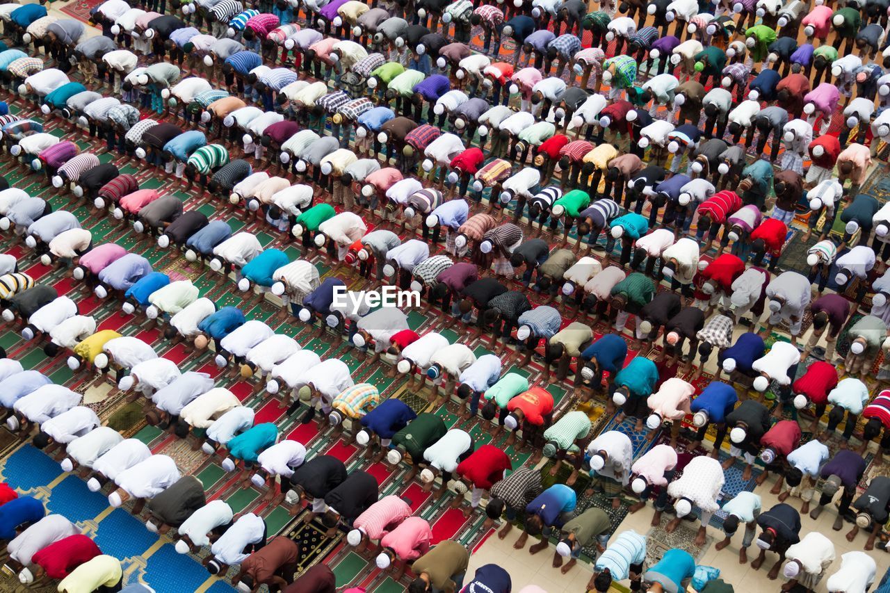 High angle view of men praying in mosque