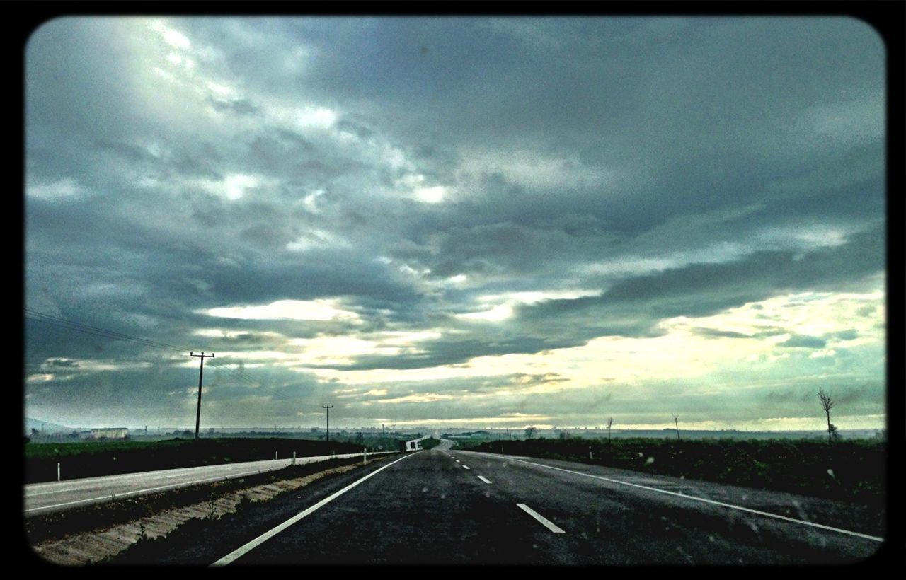 cloud, transportation, sky, road, mode of transportation, horizon, nature, vehicle interior, the way forward, car, no people, windshield, auto post production filter, sign, travel, vanishing point, highway, darkness, motor vehicle, car interior, storm, glass, marking, transfer print, road marking, environment, diminishing perspective, light, outdoors, transparent, symbol, sunlight, horizon over land, day, land vehicle, overcast, landscape, cloudscape
