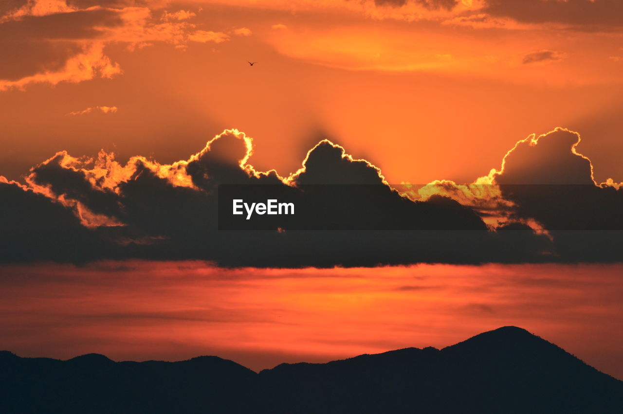 Scenic view of silhouette mountains against sky during sunset