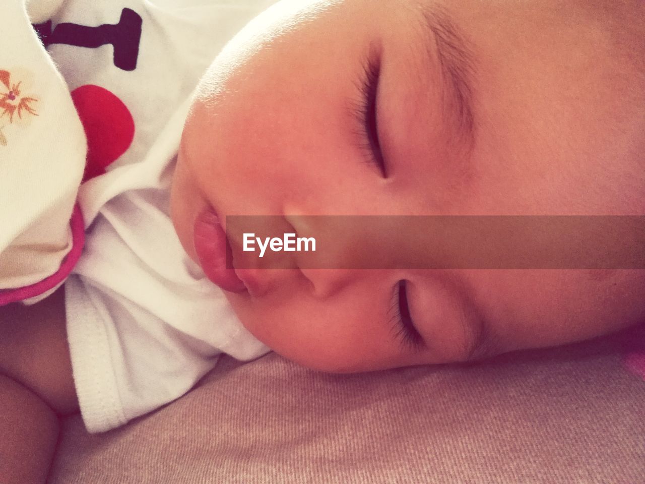 Close-up of baby boy sleeping on bed