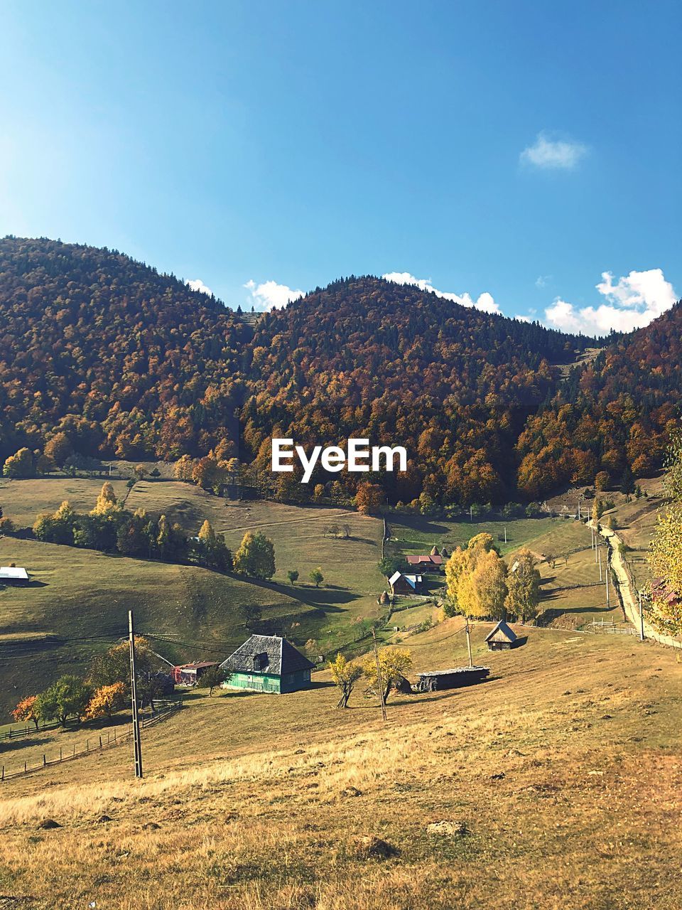 Scenic view of field by mountains against sky