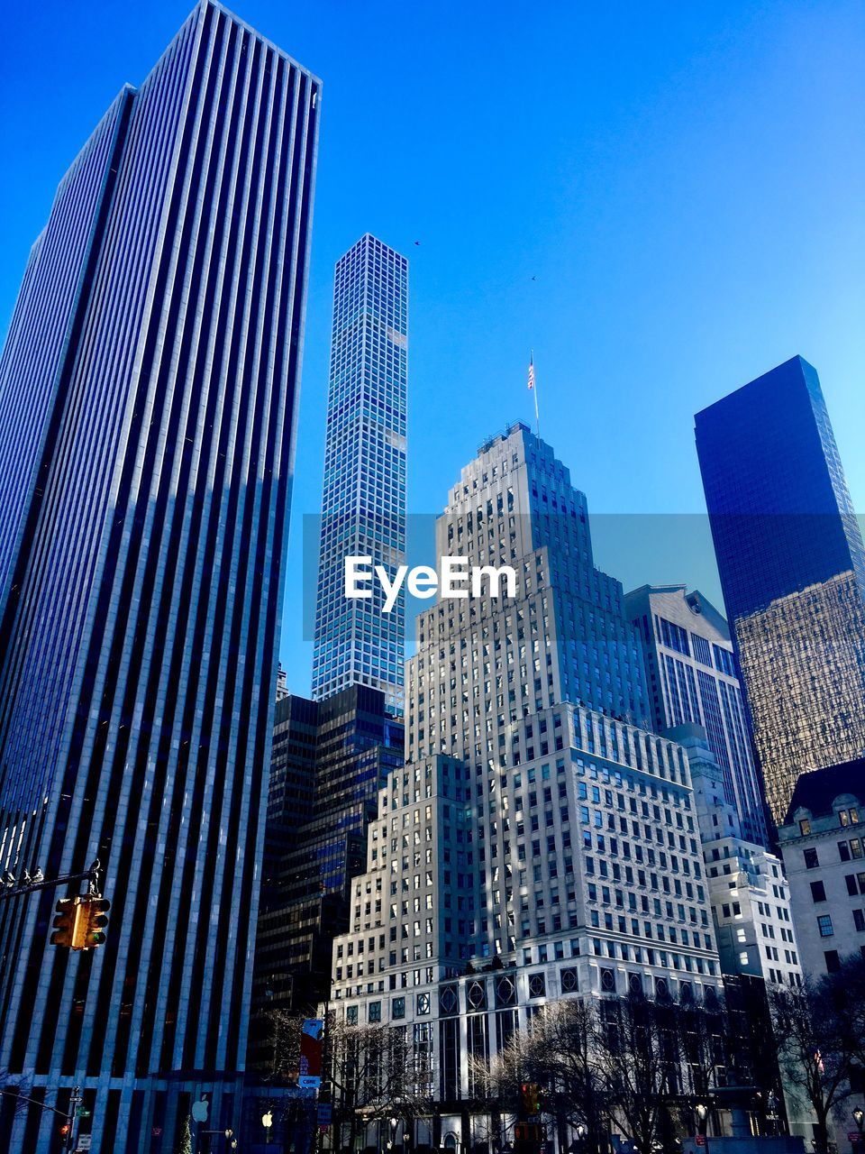 Low angle view of skyscrapers against clear blue sky