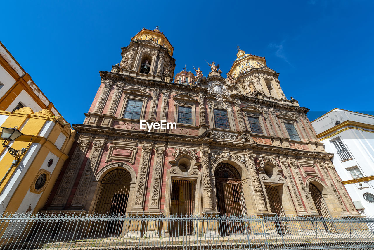 Low angle view of cathedral and building against blue sky