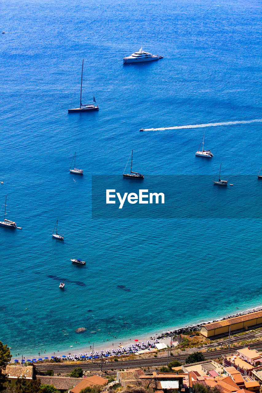 High angle view of sailboats moored on sea