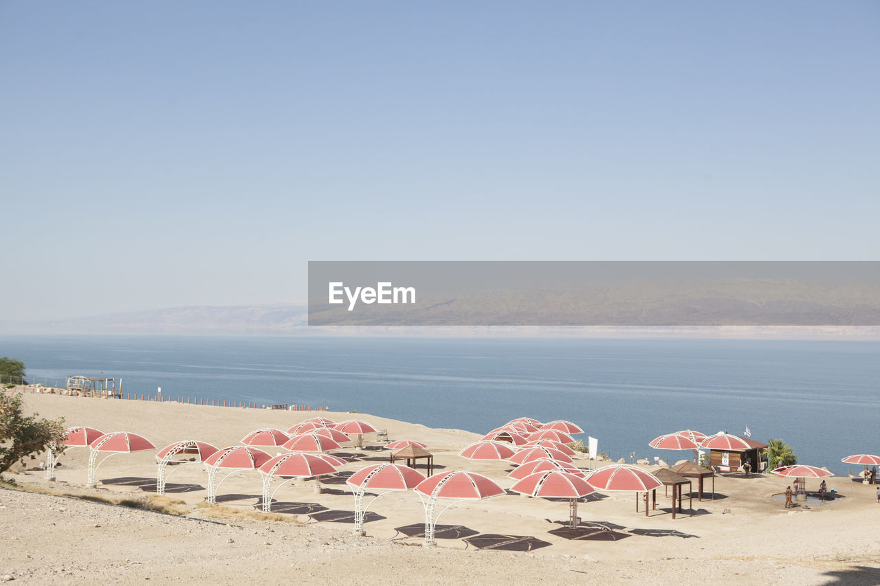 Sunshades on beach against sky