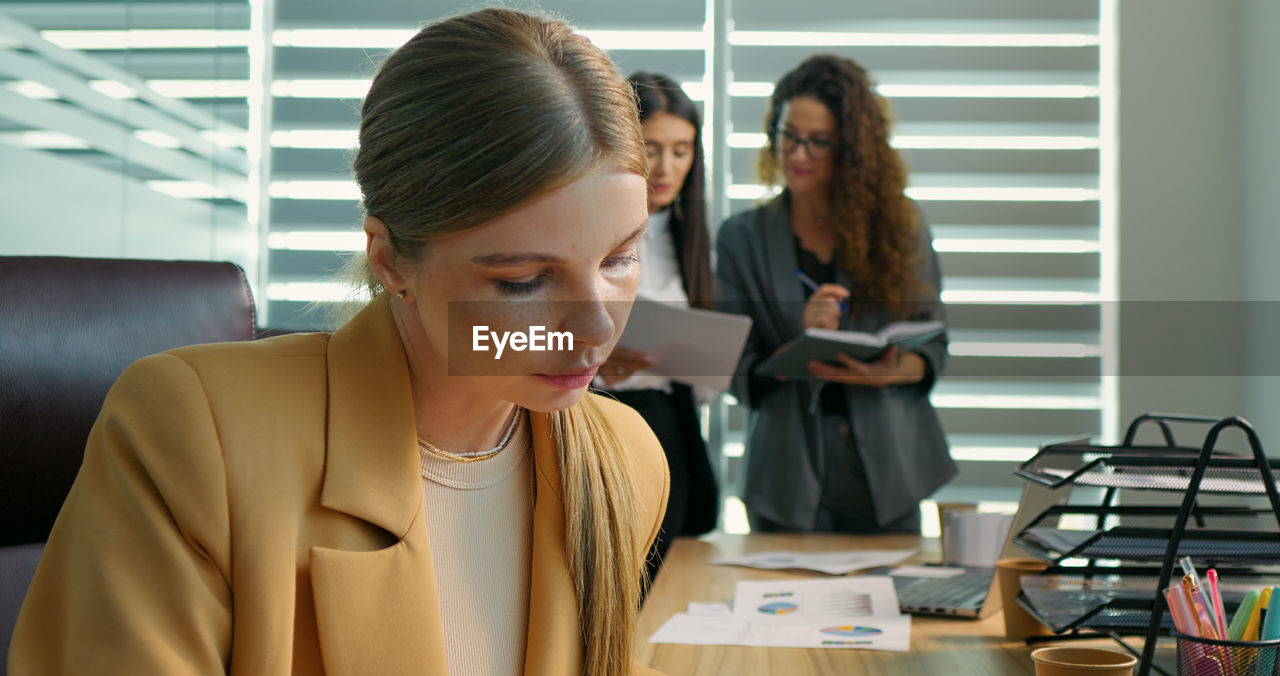 Concentrated woman working online on computer at office. 