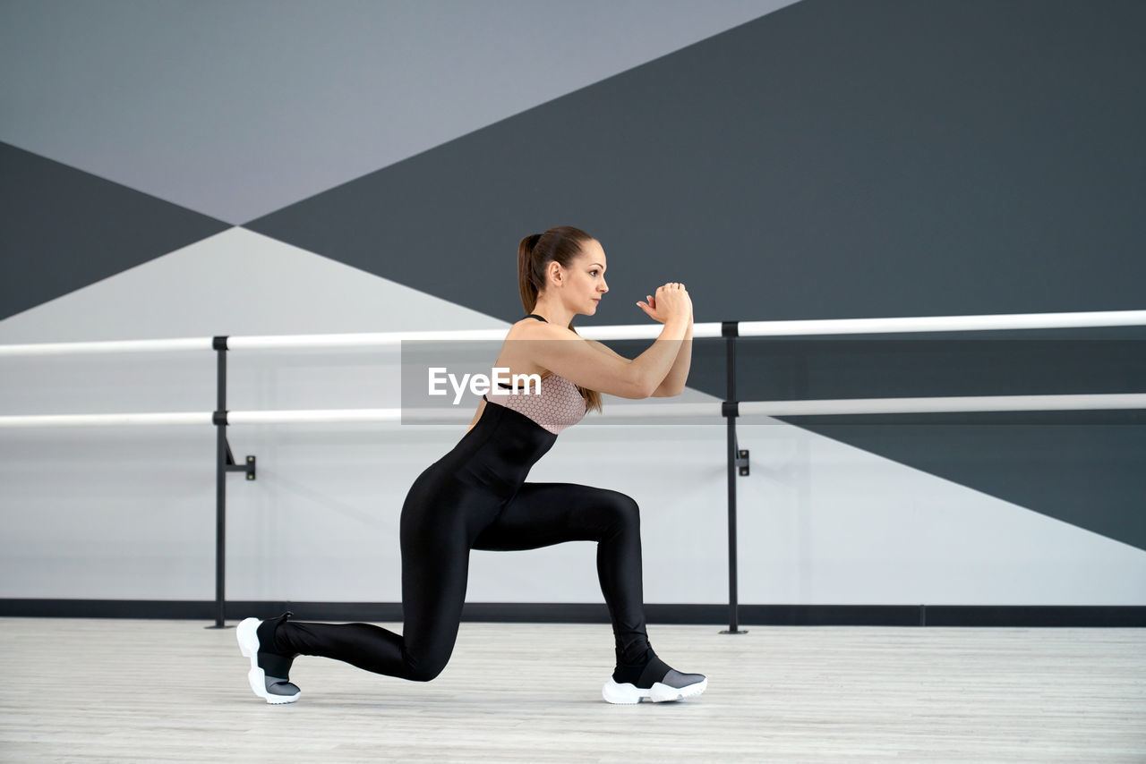 Woman exercising in hall
