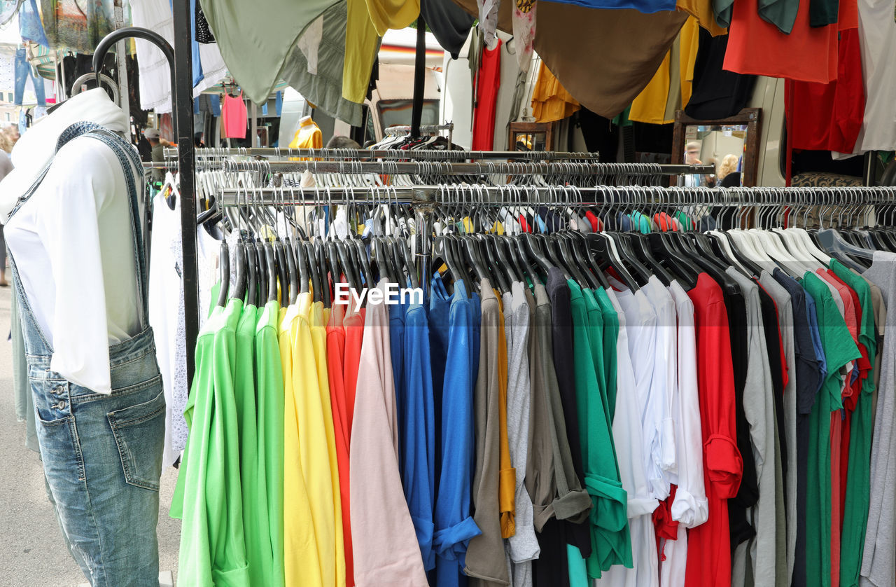 Stand of clothes at outdoor market in the street