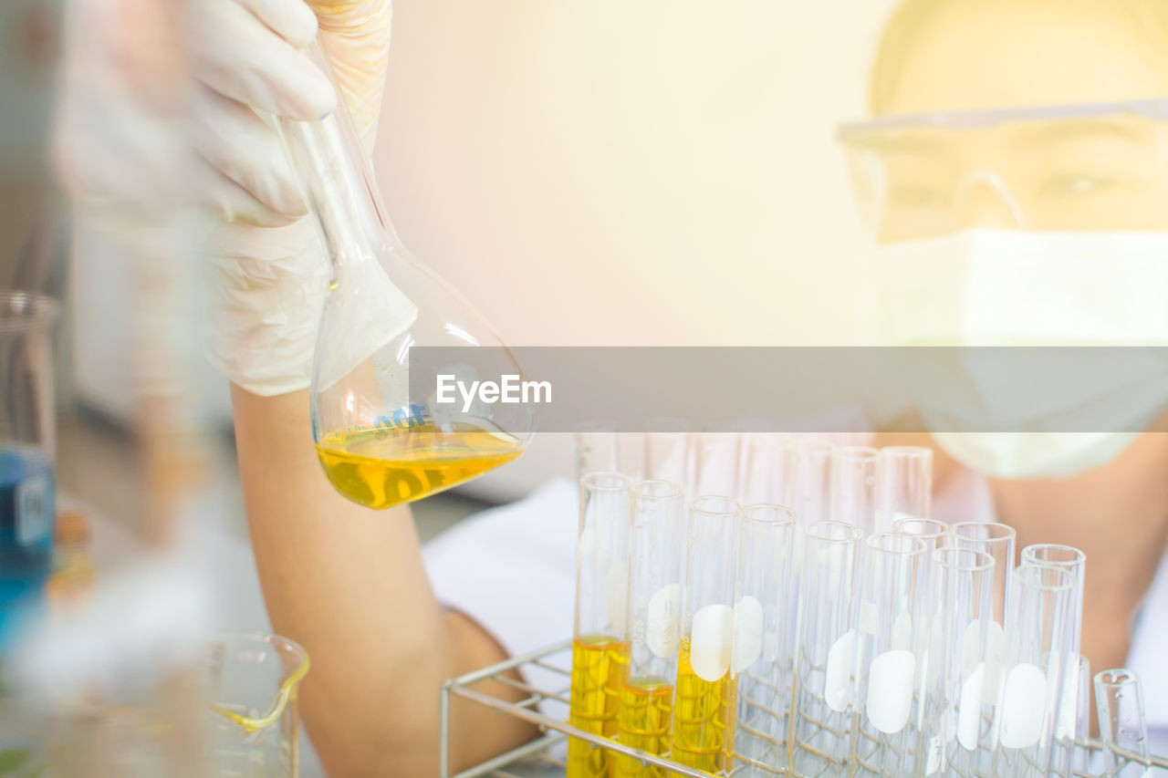 Close-up of female scientist experimenting in laboratory