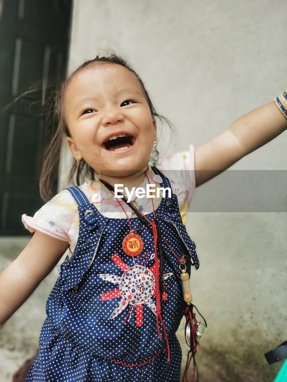 childhood, child, one person, emotion, happiness, smiling, women, female, portrait, innocence, cute, person, cheerful, fun, toddler, clothing, standing, waist up, front view, lifestyles, enjoyment, looking at camera, casual clothing, baby, laughing, positive emotion, arm, dress, spring, joy, day, carefree, limb, focus on foreground, outdoors, architecture