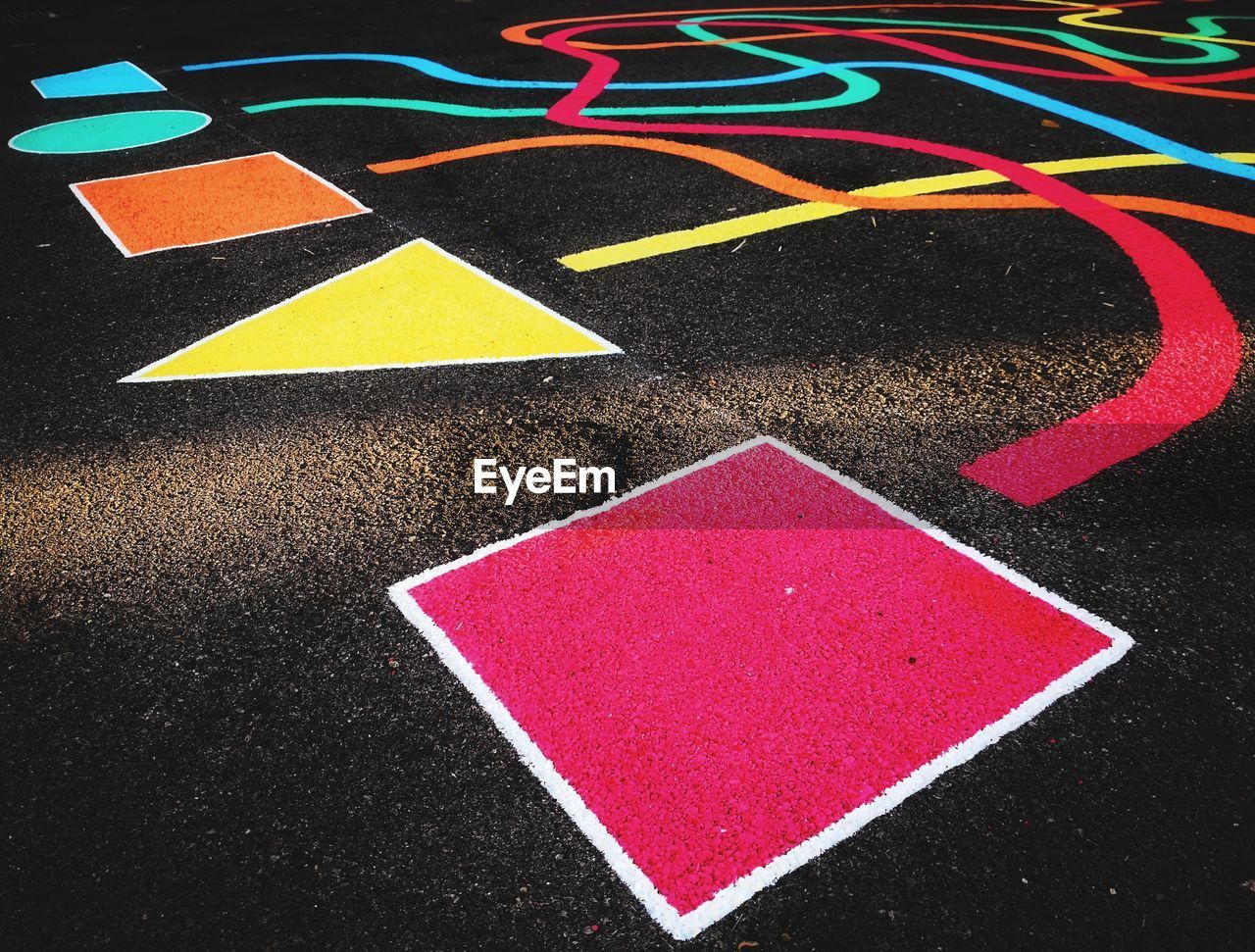 High angle view of multi colored pattern on road