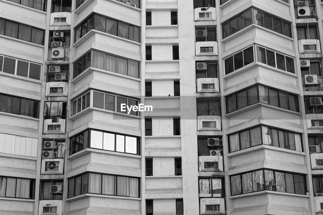 architecture, built structure, building exterior, tower block, building, residential area, window, full frame, city, no people, condominium, neighbourhood, residential district, backgrounds, apartment, facade, metropolis, low angle view, pattern, skyscraper, day, repetition, urban area, balcony, outdoors, black and white, in a row, monochrome, house