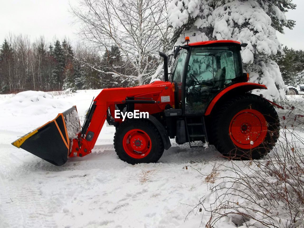 TRACTOR ON SNOWY FIELD