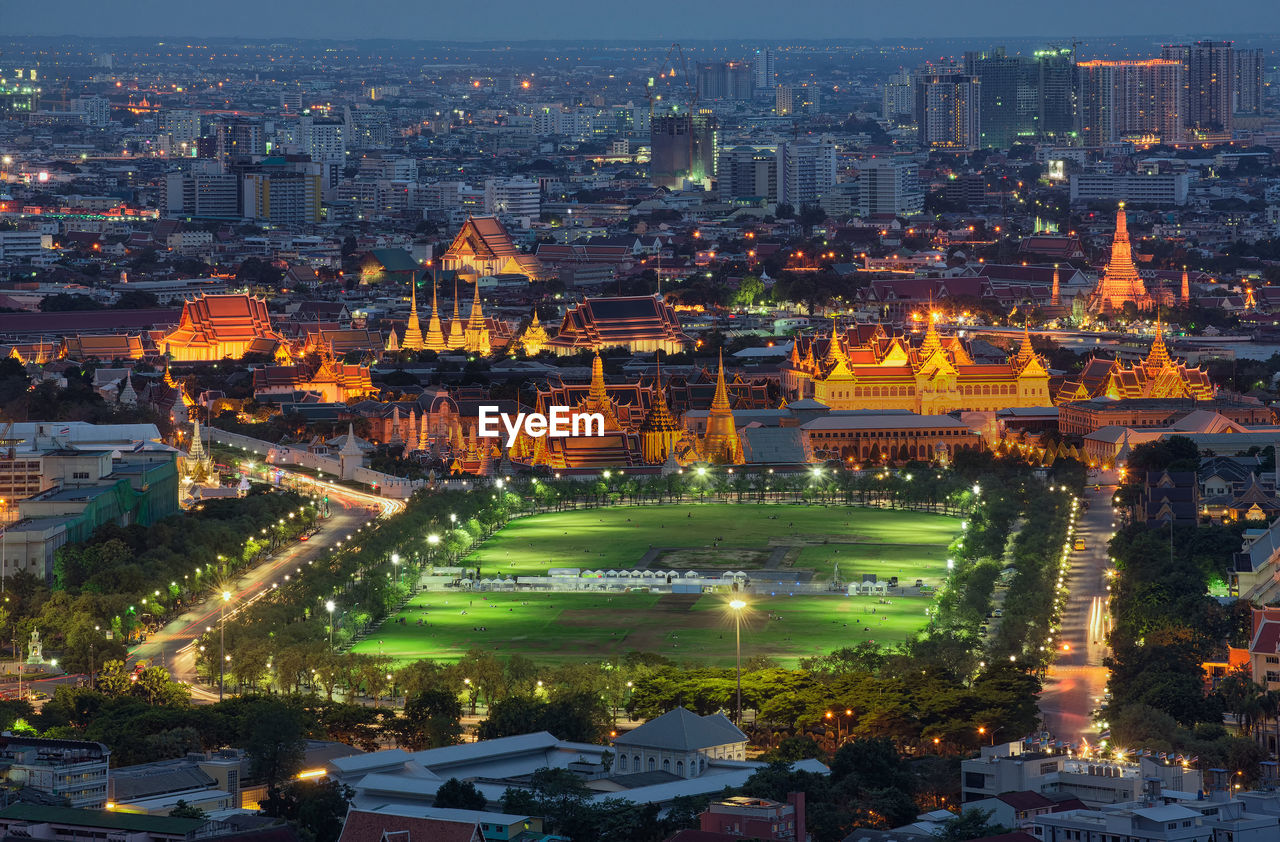 Aerial view of illuminated cityscape during sunset