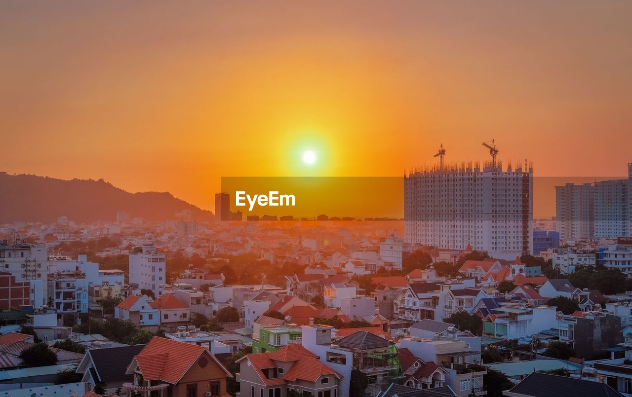 CITYSCAPE AGAINST SKY DURING SUNSET