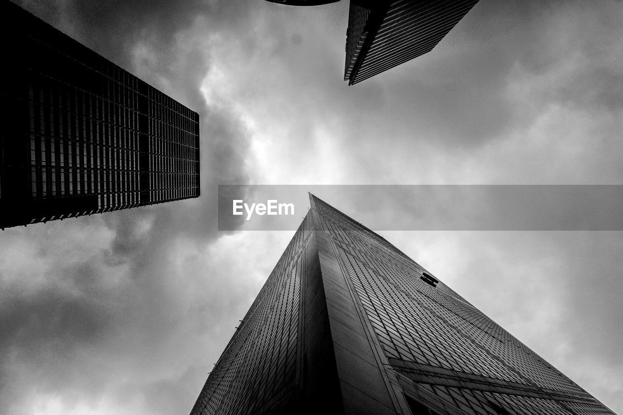 Directly below view of modern office buildings against sky