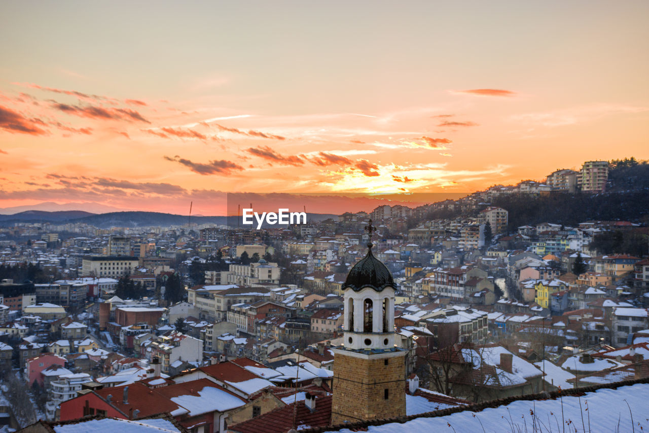 CITYSCAPE AGAINST CLOUDY SKY