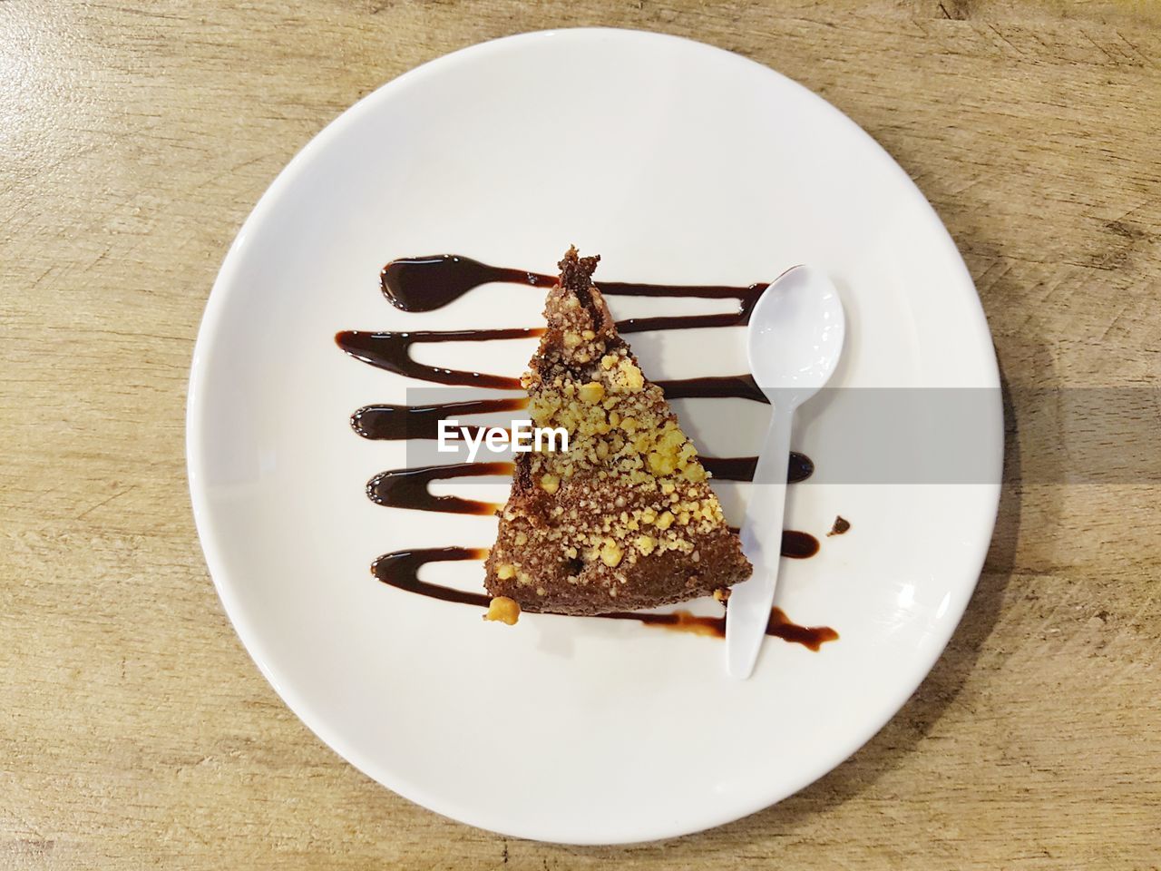 Directly above shot of cake and spoon on plate