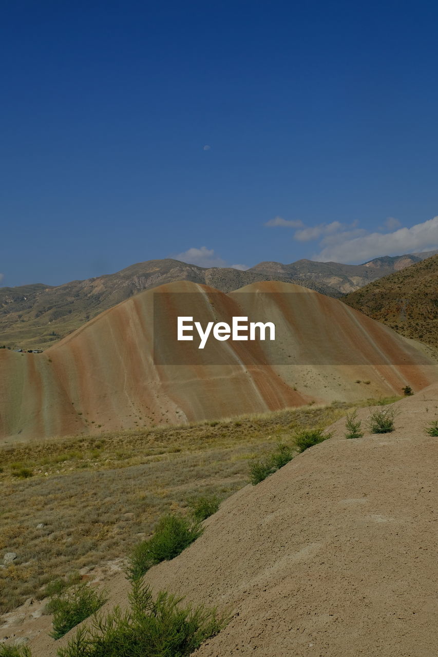 nature, terrain, cliff, land, scenics - nature, no people, sky, beauty in nature, blue, tranquility, day, landscape, environment, outdoors, travel, non-urban scene, travel destinations, tranquil scene, mountain, plant, wall, rock, clear sky, architecture, tourism, geology