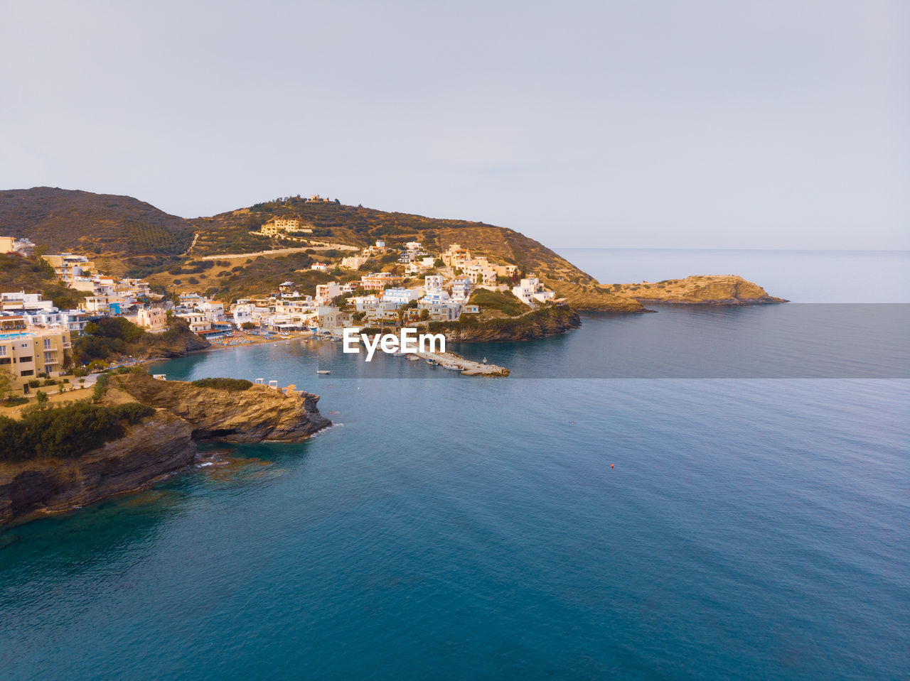 Aerial view of a scenic village on crete at the sea against clear sky