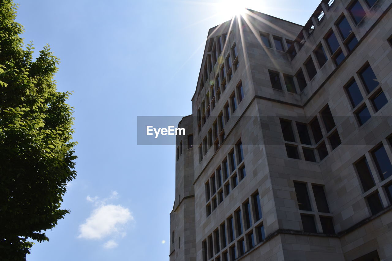 LOW ANGLE VIEW OF BUILDING AGAINST BLUE SKY