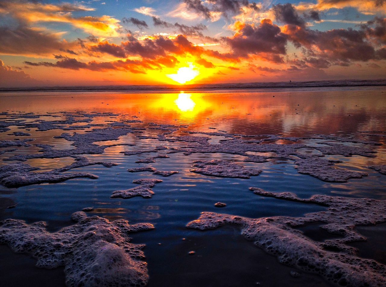 Scenic view of sea against orange sky