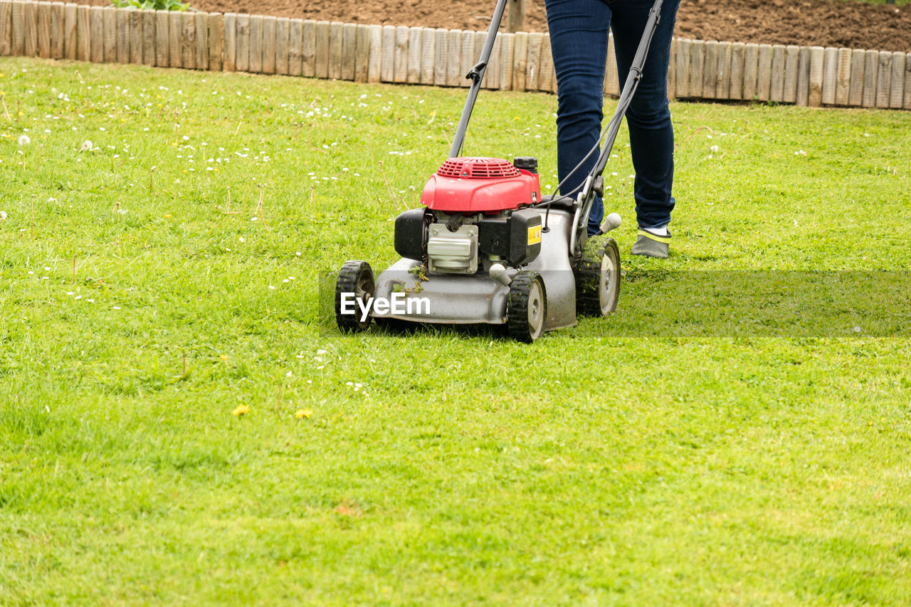 LOW SECTION OF MAN WORKING IN BACK YARD