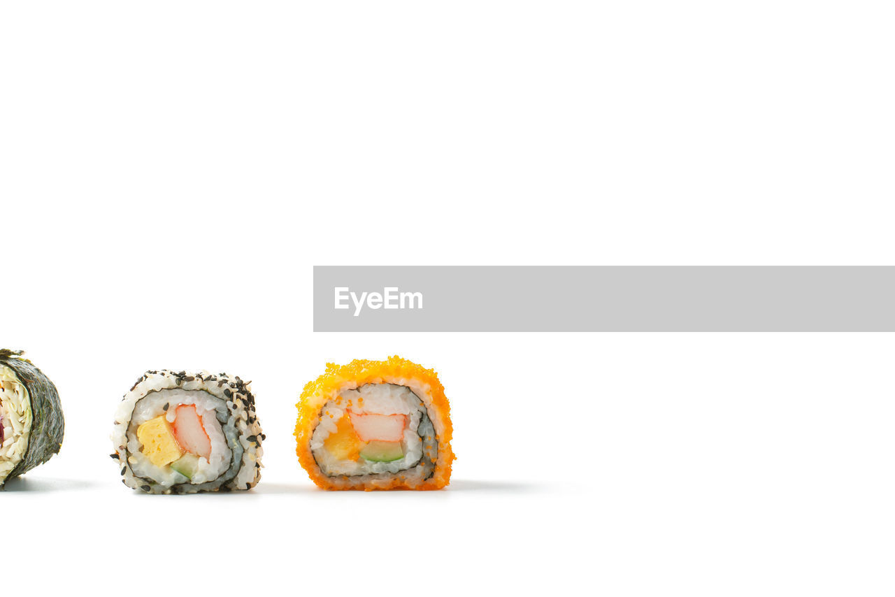 CLOSE-UP OF SUSHI ON WHITE BACKGROUND