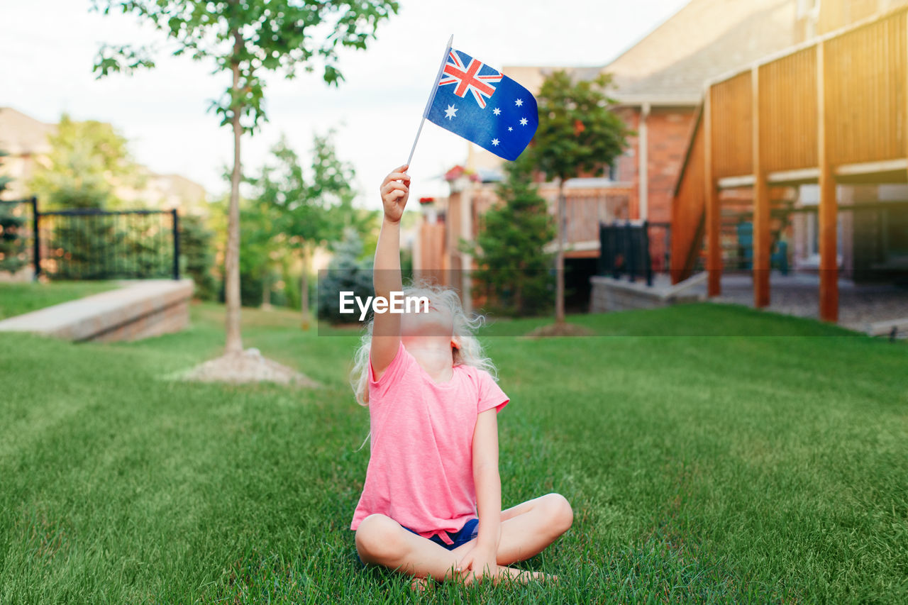 Adorable cute happy caucasian girl holding australian flag. 