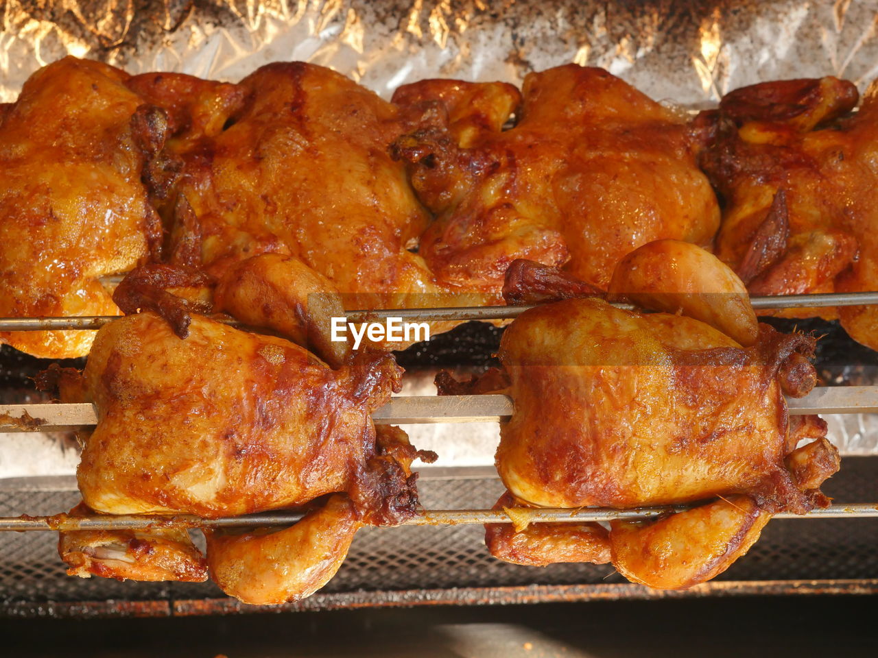 Close-up of spit roasted chicken for sale at market stall