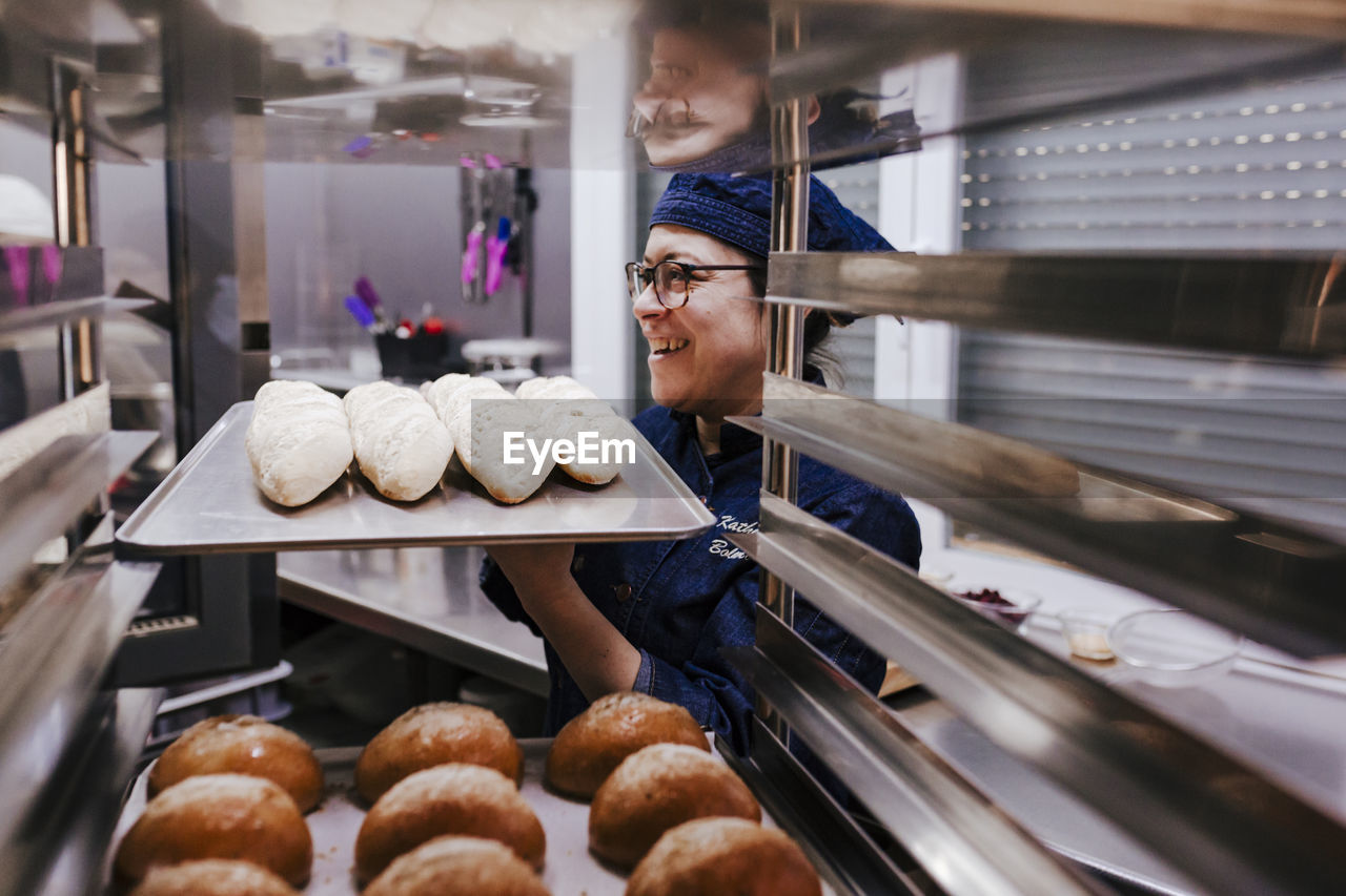 Woman holding food in tray at bakery