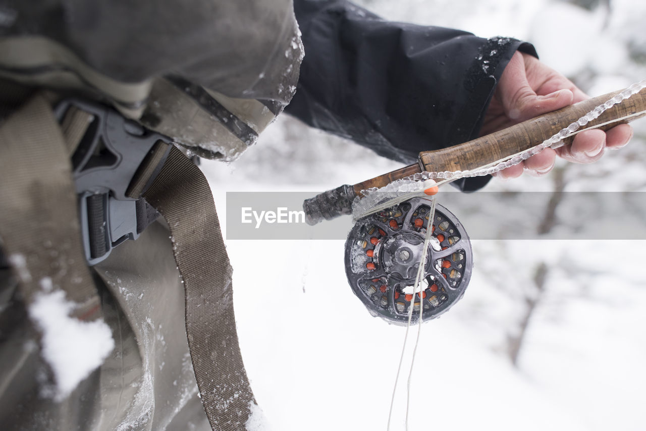 A fly fisherman's rod covered in ice.