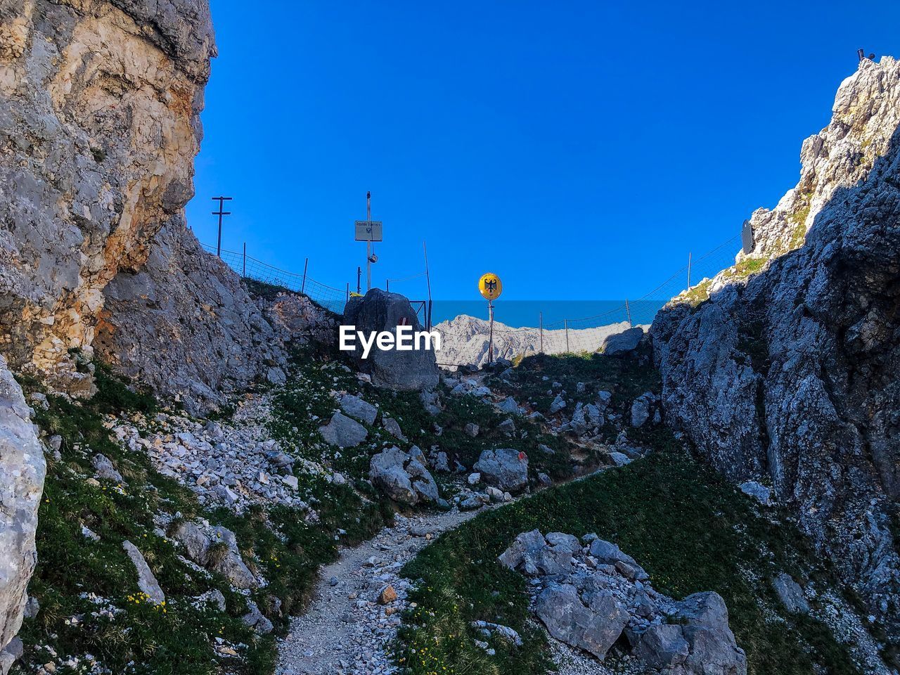 LOW ANGLE VIEW OF ROCKS AMIDST BUILDINGS AGAINST CLEAR SKY