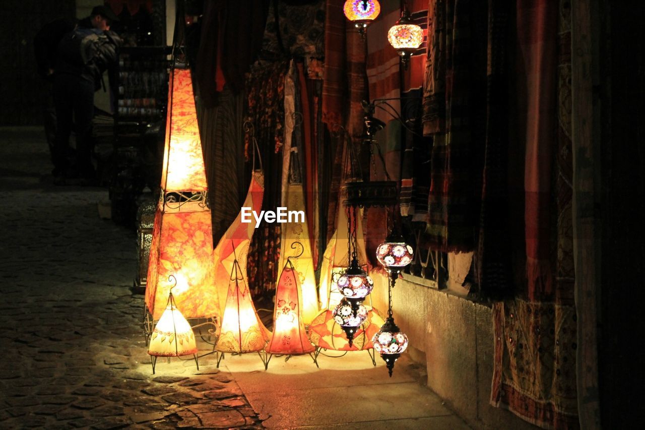 Illuminated lanterns by street at night