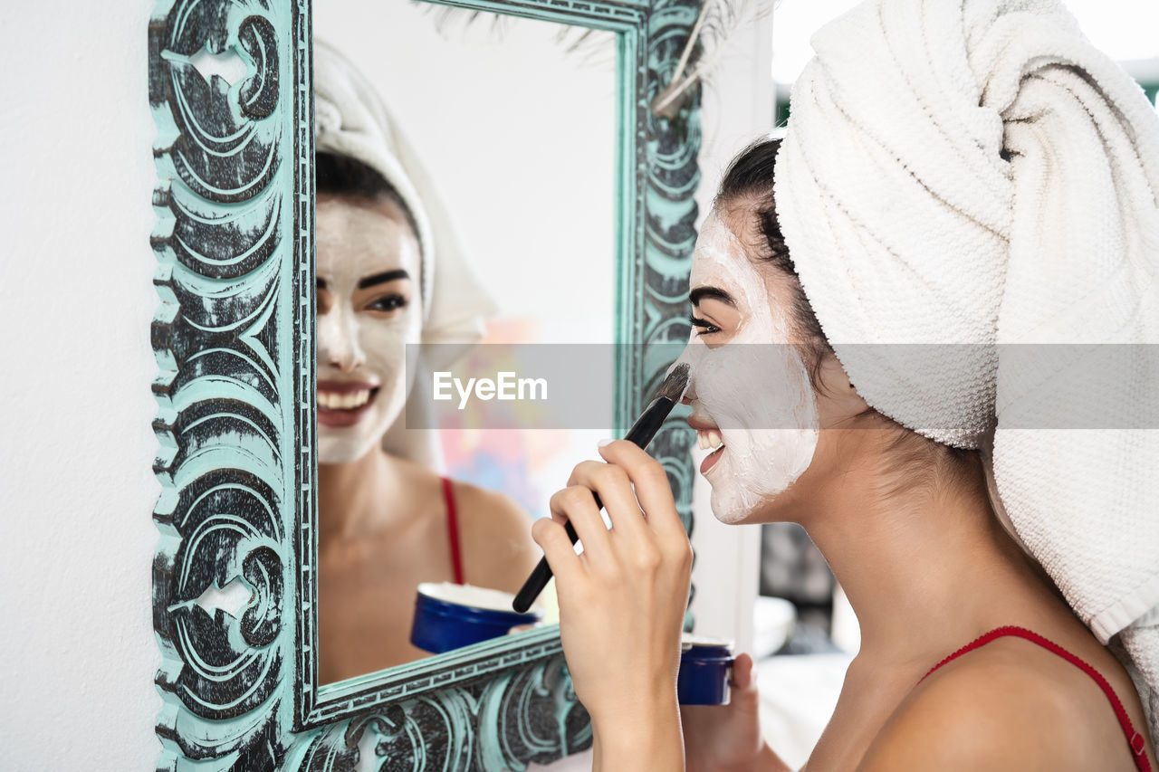 Close-up of woman by mirror