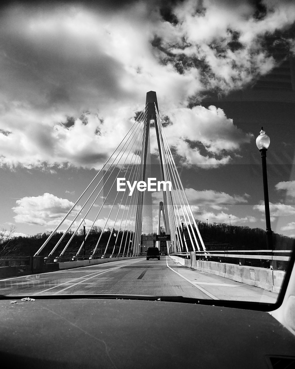Suspension bridge seen from windshield against sky
