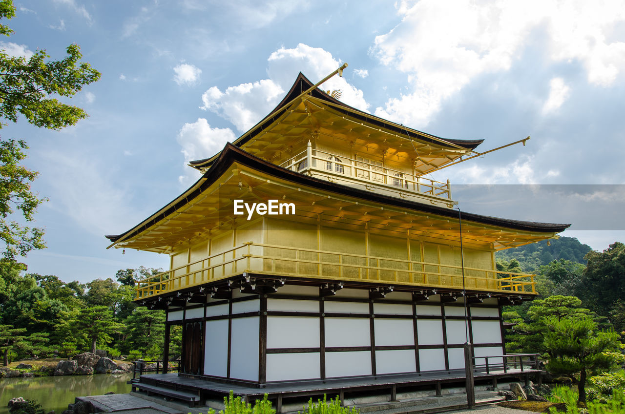 LOW ANGLE VIEW OF YELLOW BUILDING AGAINST SKY