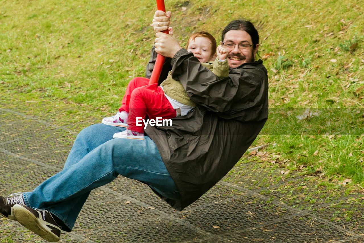 Father and son enjoying ride at park