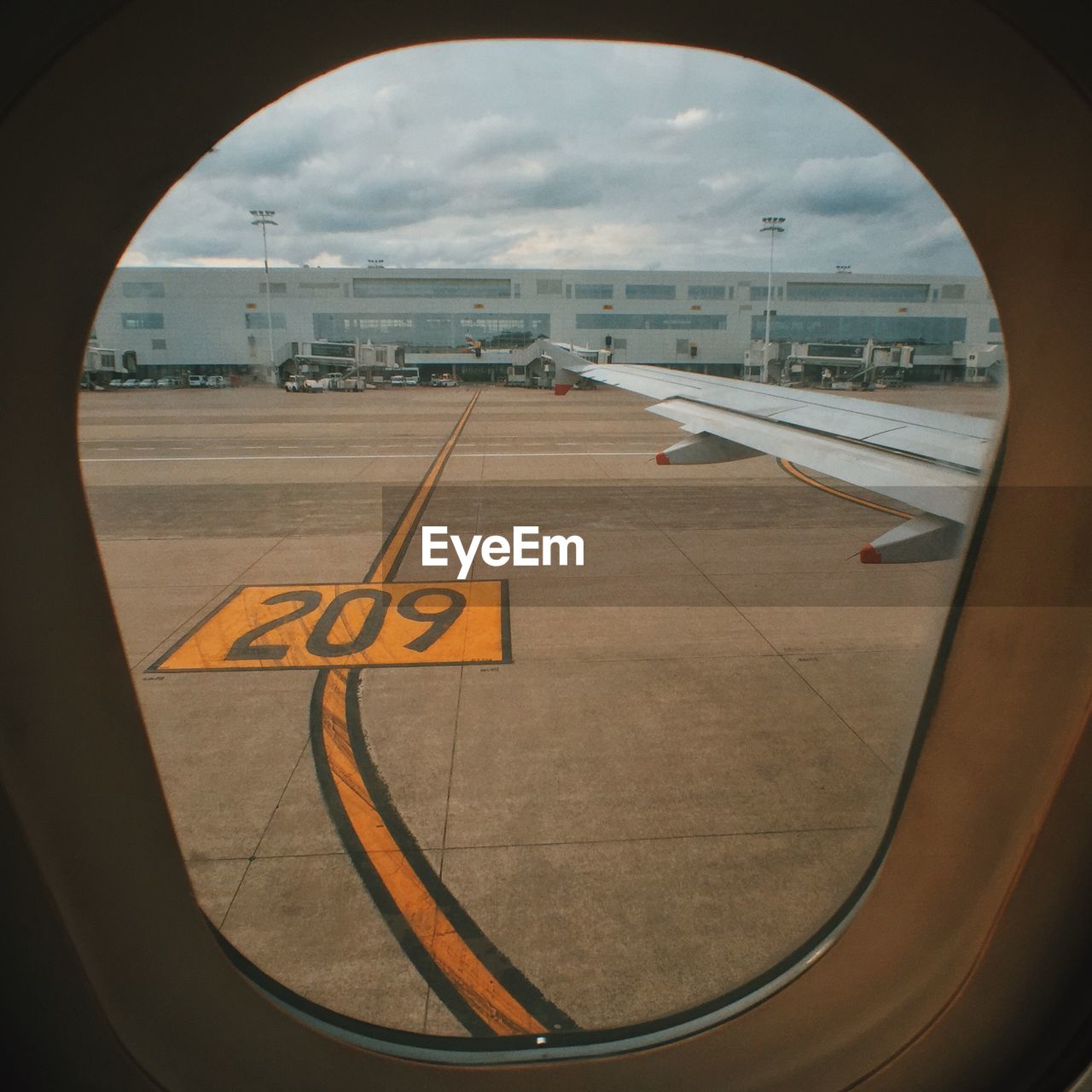 Cropped image of airplane seen through window