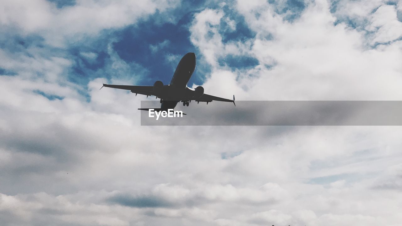 LOW ANGLE VIEW OF AIRPLANE IN SKY