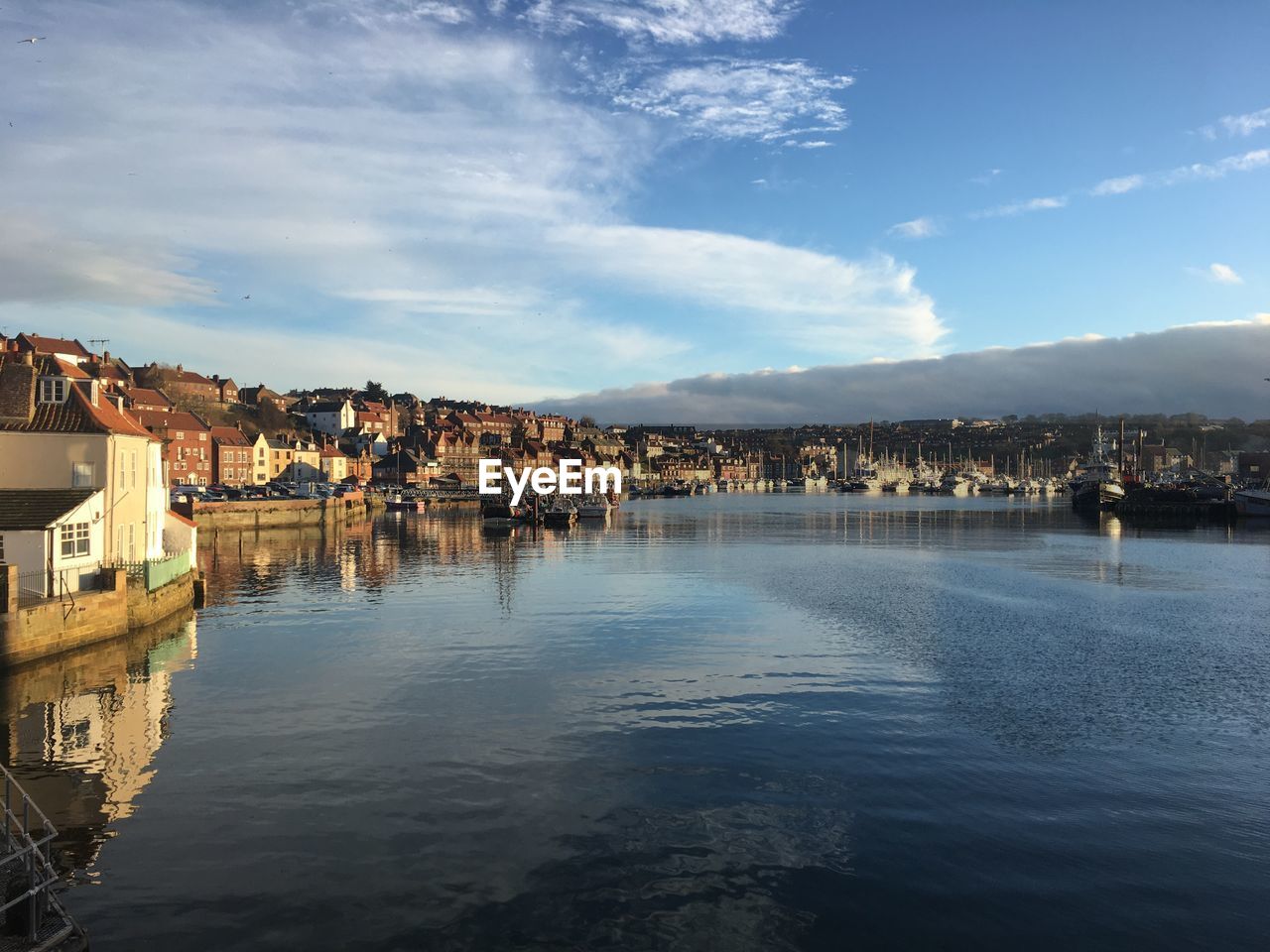 TOWN BY LAKE AGAINST SKY